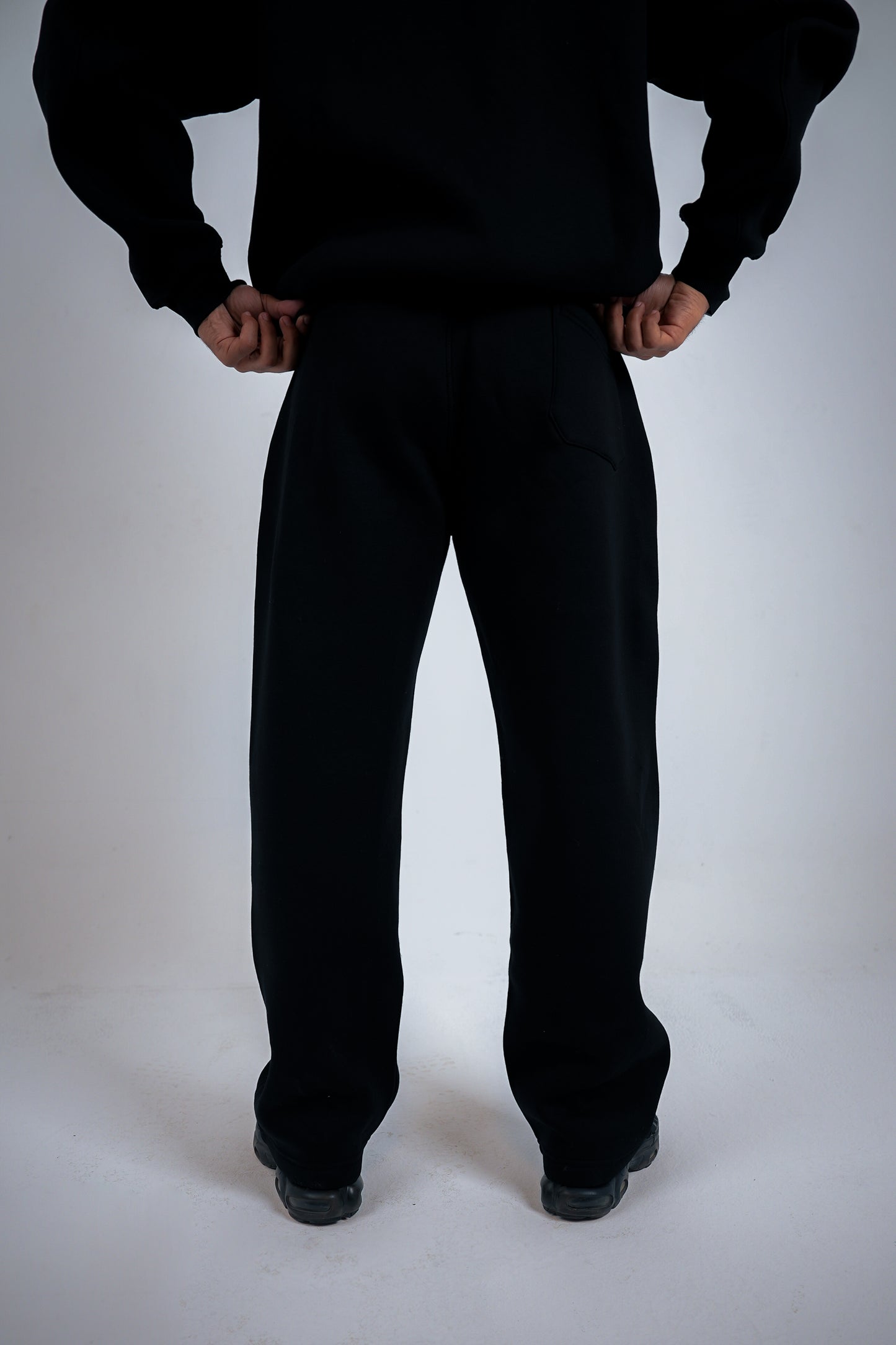 Person wearing a black suitcase on a white background