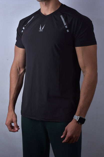 Person wearing a 'RAVIX' black athletic outfit with RAVIX logo on a gray background