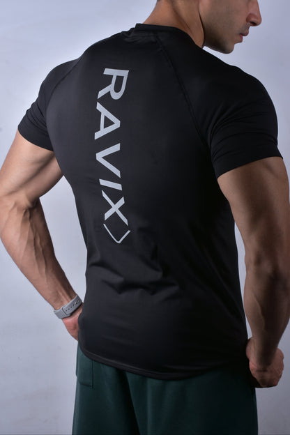 Man wearing a compression black beam t-shirt with 'RAVIX' logo on the back against a gray background