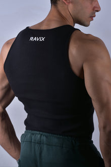 Man wearing a black tank top with 'RAVIX' branding on the back against a plain background