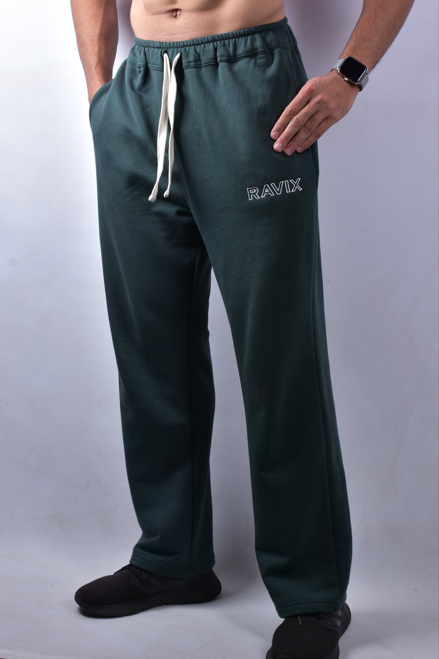 Green pants with 'RAVIX' branding on a white background