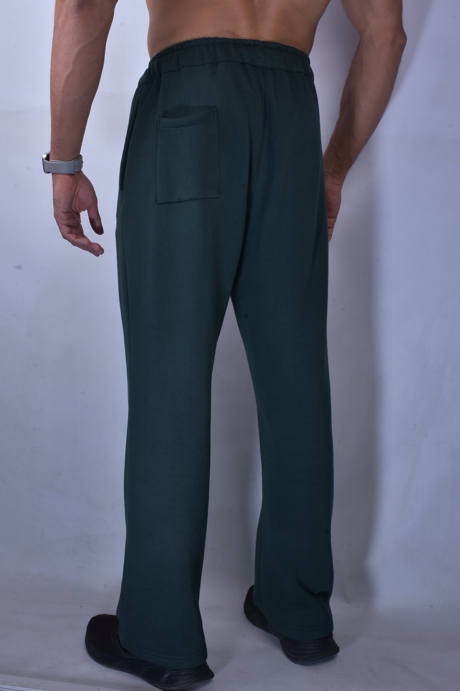Person wearing dark green pants on a white background
