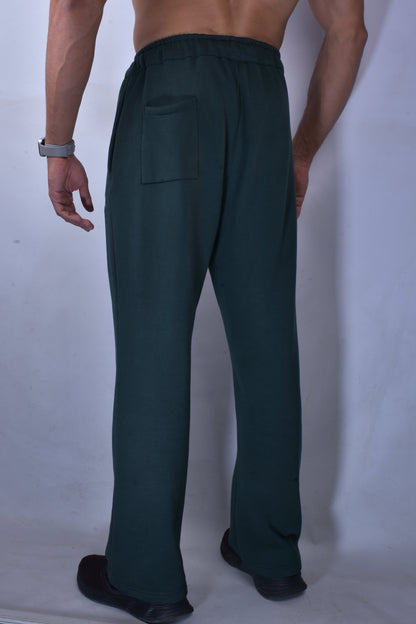 Person wearing dark green pants on a white background