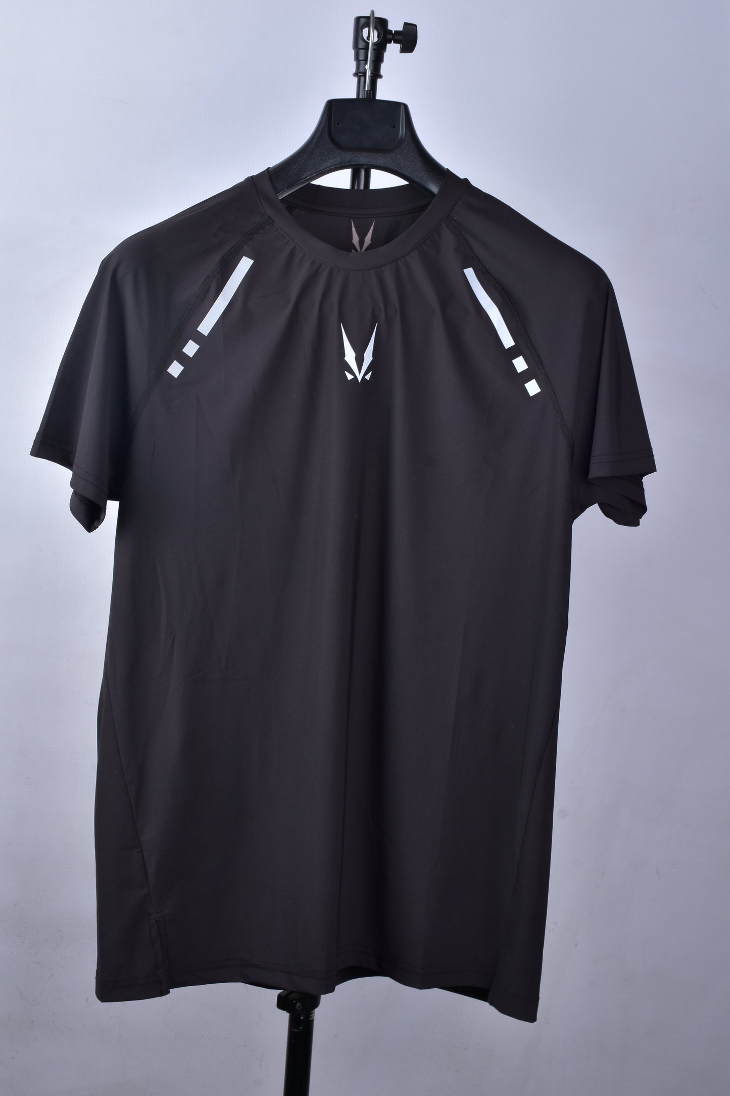 RAVIX black regular t-shirt with white logo on a hanger against a gray background